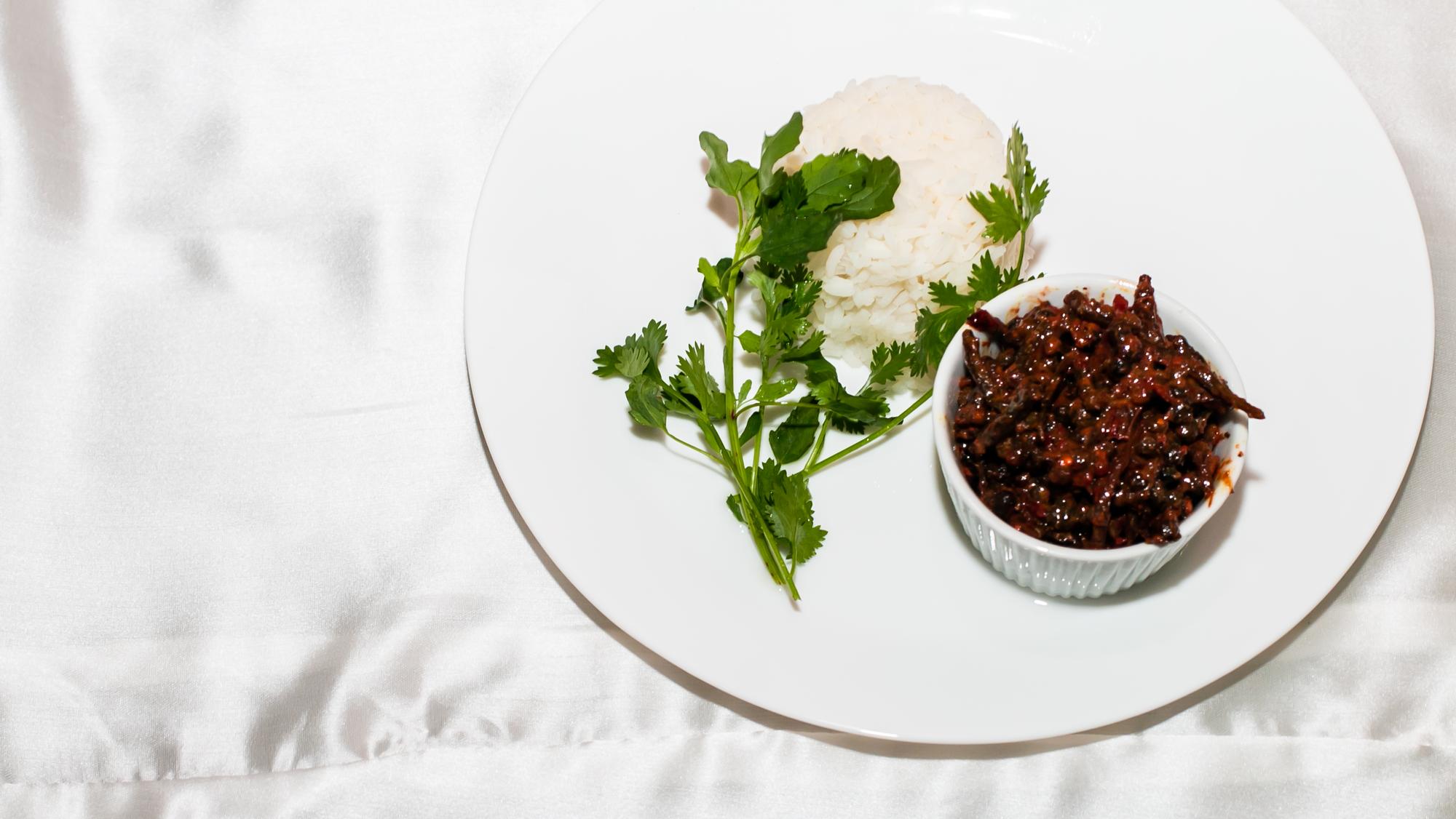 Plated dish with sauce and herbs