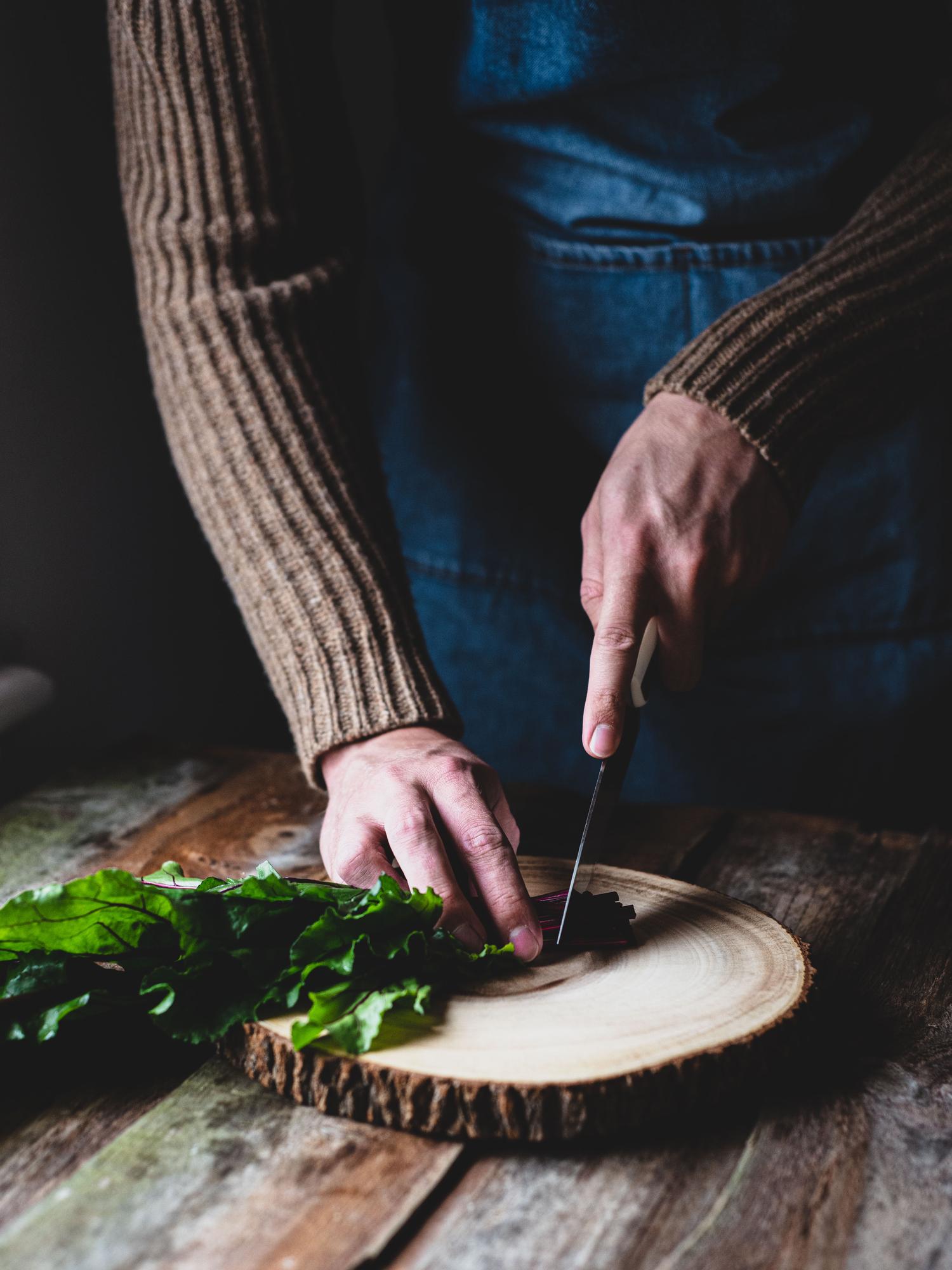 Chef preparing a rustic plate with herbs